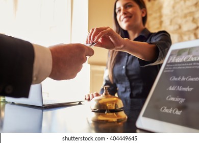 Guest takes room key card at check-in desk of hotel, close up - Shutterstock ID 404449645