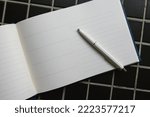 Guestbook and white pencil, top view as copy space