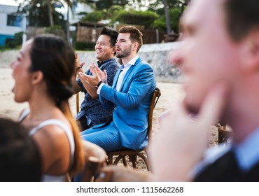 Guests Attending A Beach Wedding Ceremony