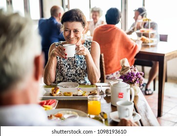 Guests Eating Breakfast At Hotel