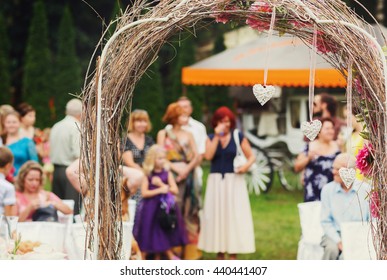 Guests stand behind a gray wedding altar - Shutterstock ID 440441407