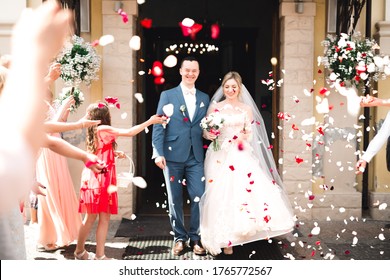 Guests Throwing Confetti Over Bride And Groom At Wedding