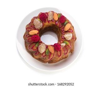 Gugelhupf Marble Bundt Cake, Filled With Dried Blackcurrant And Chestnut Paste, Garnished With Blackcurrant Icing, Marron Glace, Whole Almonds, Freeze-dried Raspberry, Pistachios, And Silver Dragees.