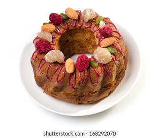 Gugelhupf Marble Bundt Cake, Filled With Dried Blackcurrant And Chestnut Paste, Garnished With Blackcurrant Icing, Marron Glace, Whole Almonds, Freeze-dried Raspberry, Pistachios, And Silver Dragees.