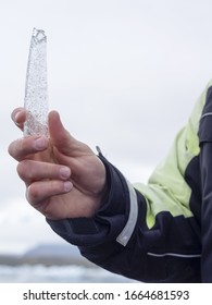 A Guide Holding An Ice Core Sample From The Glacial Lagoon In His Hand.