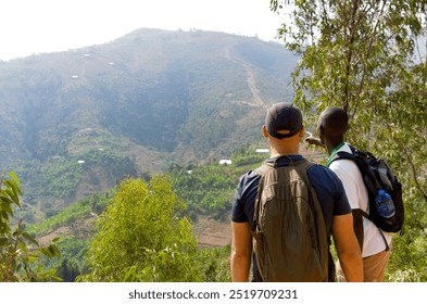 Guide pointing out something on a hike around the town of Kibuye, by Lake Kivu, Rwanda.