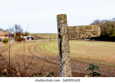 guide post made of stone in the field