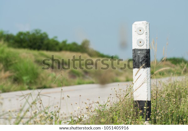 The guide post is right on the road\
warns car users to use the road. Perseverance\
concept