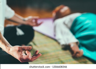 Guided meditation. Senior woman and mid adult woman lying on the floor and meditating