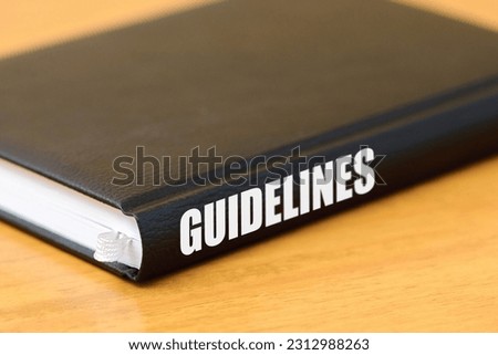 Guidelines black book on the wooden table.