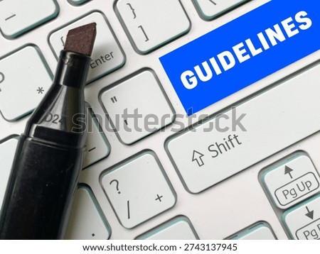 Guidelines key on computer keyboard with office tools, workplace rules and corporate compliance concept.