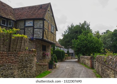 Guildford, England - August 2, 2019: Stone and tile Cottage at Shere in Surrey.