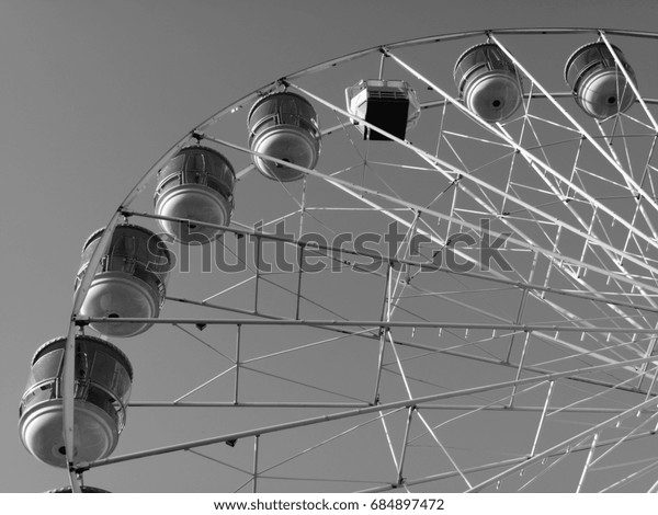 Guildhall Square, Salisbury,\
Wiltshire, England - July 25, 2017: Monochrome Salisbury Eye Ferris\
Wheel stands 115 feet high, annual summer feature to the\
city