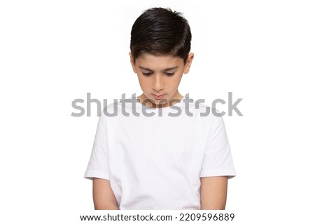 Guilty. Concept of accusation guilty person little boy. Sad upset kid looking down with arms crossed. Human face expression emotion feeling. Isolated on the white background