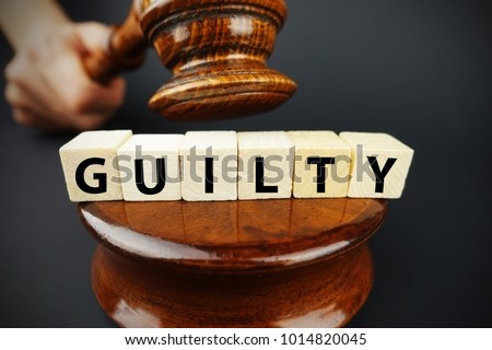 Guilty court decision with judge gavel and wooden cubes with text
