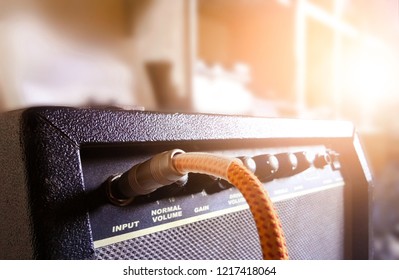 Guitar Amplifier With Audio Cable In Recording Studio Background Beautiful Sunlight And Copy Space, Music Concept. Selective Focus. Warm Tone Image