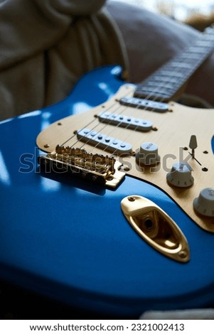 guitar with blue color body and gold anodized pickguard
