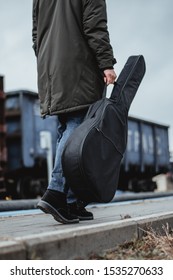 Guitar in a case in the hands of a guy