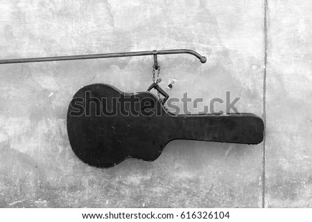 Guitar case on the background of a concrete wall