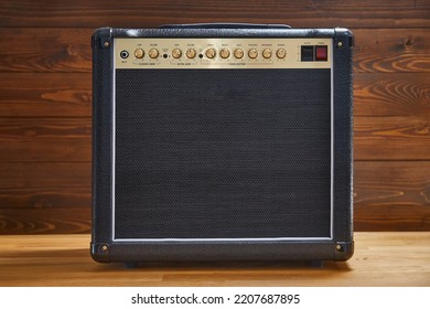 Guitar Combo Amplifier In Front Of Lumber Wall