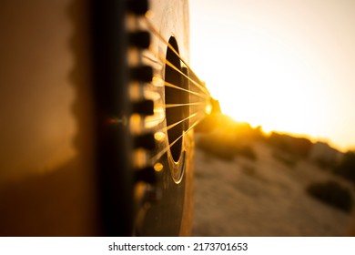 Guitar during the sunset.Playing guitar with some friends during the golden hour in the nature,just an hour before the nightfall. - Shutterstock ID 2173701653