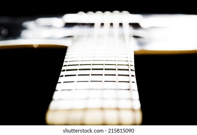 Guitar fingerboard and close up frets, limited focus.