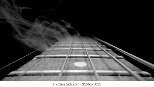 Guitar fretboard with sliding in black and white closeup