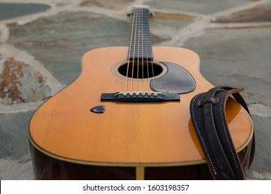 Guitar Laying Down With Strap