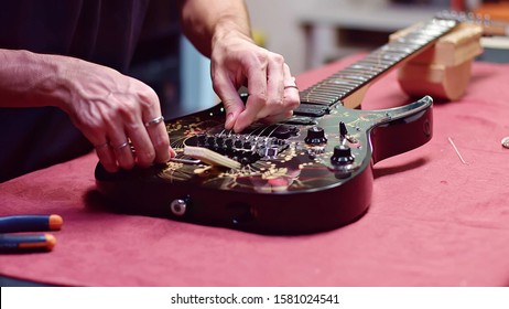 Guitar Maker Change Strings Of Electric Guitar
