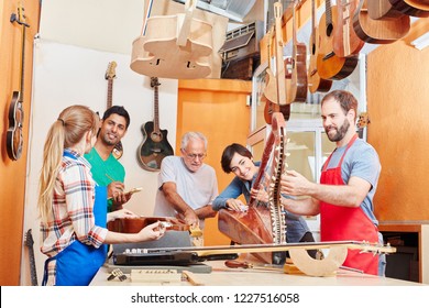 Guitar makers in small and traditional business workshop  - Powered by Shutterstock