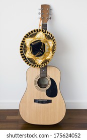 Guitar with Mexican sombrero on dancing floor