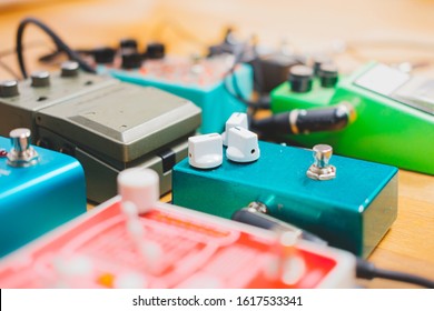 Guitar Pedalboard On The Floor Of A Recording Studio. Generic Guitar Effects On The Wooden Floor. Guitar Recording, Rock Music Creation Concept