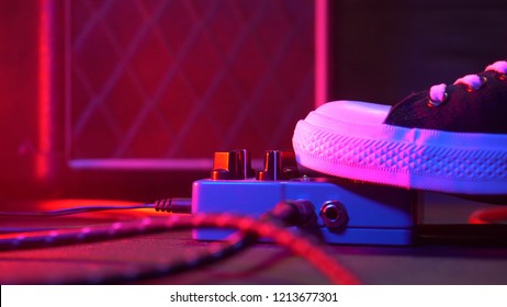 Guitar pedals and footswitch inside recording room. Close up of guitar pedals and musician's foot tapping on it for different sounds. Macro view - Powered by Shutterstock