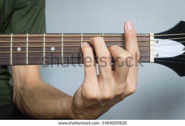 Guitar\
Player Hand or Musician Hand in F Major Chord on Acoustic Guitar\
String with soft natural light in close up\
view