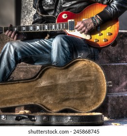 Guitar Player With An Open Guitar Case In Hdr