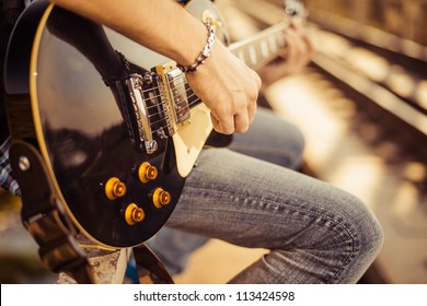 guitar player playing song outdoor - Shutterstock ID 113424598