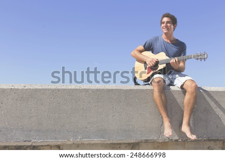 Similar – Young musician enjoying guitar on sunny day