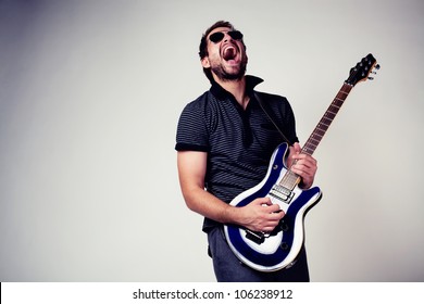 Guitar player. Rockstar playing on guitar. Wearing sunglasses