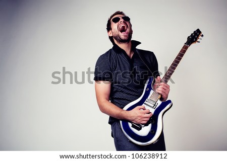 Guitar player. Rockstar playing on guitar. Wearing sunglasses