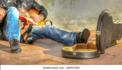 Guitar Player In The Street With An Open Guitar Case 