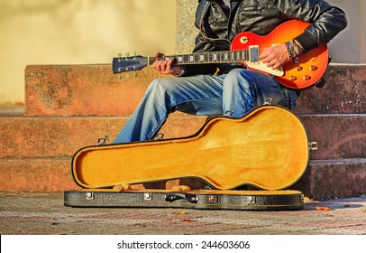 Guitar Player In The Street With An Open Guitar Case