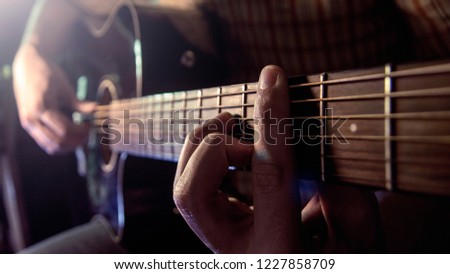 Guitar Playing. Man Playing Acoustic Guitar Closeup