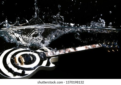 guitar under water with water splash on black background.
