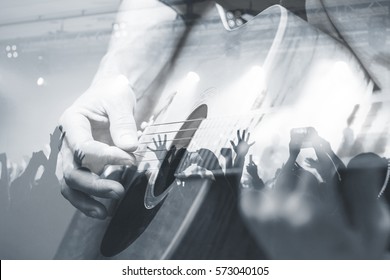 Guitarist with the audience in a double exposure.