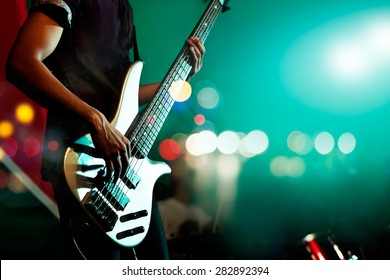 Guitarist bass on stage for background, colorful, soft focus and blur