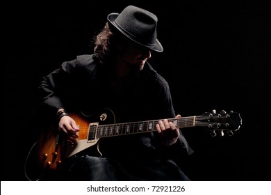 Guitarist In Black Hat Playing Guitar