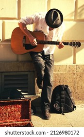 Guitarist In A Hat Playing In The Street