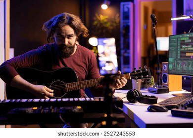 Guitarist instructor teaching guitar lessons on internet using smartphone, recording vlog as a tutorial for social media channel. Artist composer explaining acoustic instrument accords, assistance. - Powered by Shutterstock