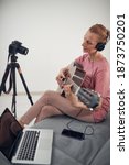 Guitarist making video lessons and tutorials for internet vlog website classes.