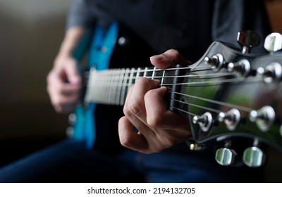 guitarist man playing guitar, practicing electric guitar, soft focus